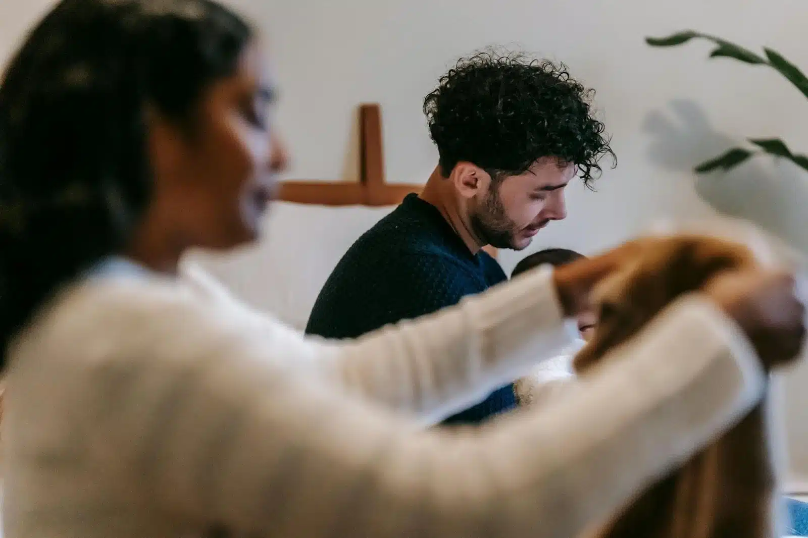 A man and woman being silent while doing house chores