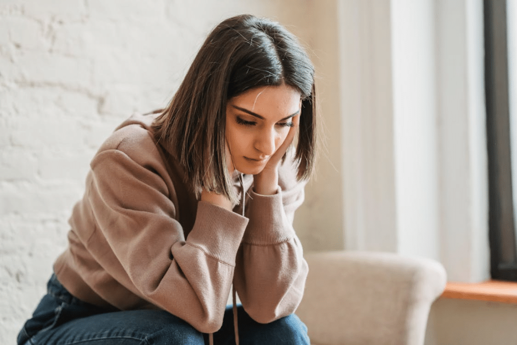 Sad woman sitting on couch