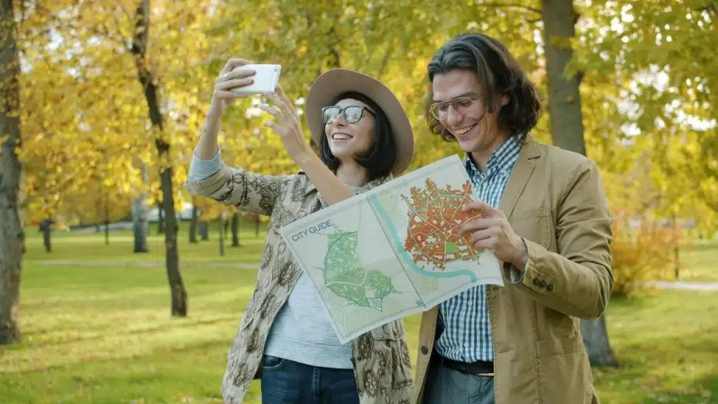 A couple looking at a map in the park
