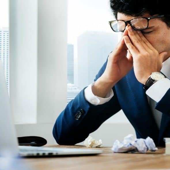 A man looking frustrated at work