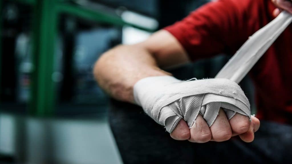 A man wrapping his hand to box