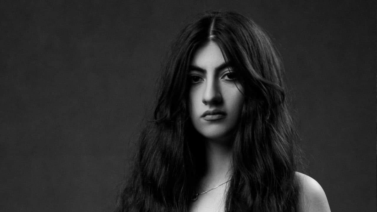 A grayscale image of a woman with open hair.