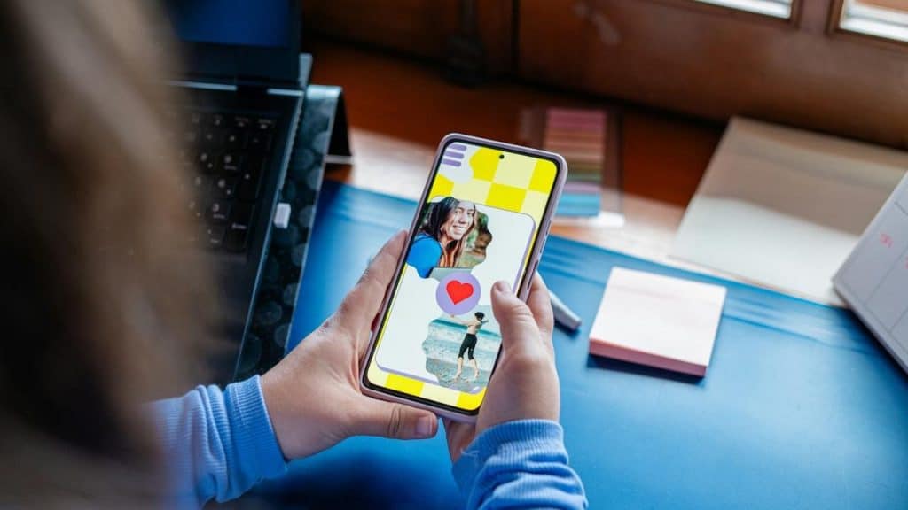 A person holding a smartphone and viewing a dating app.