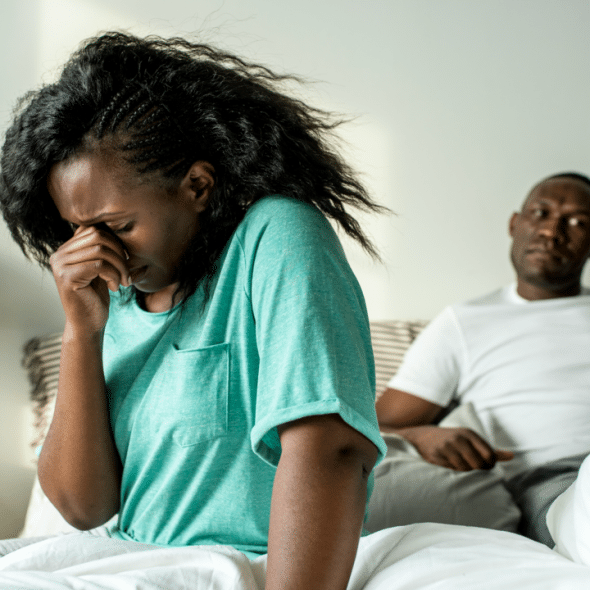 A couple looking upset in the bedroom