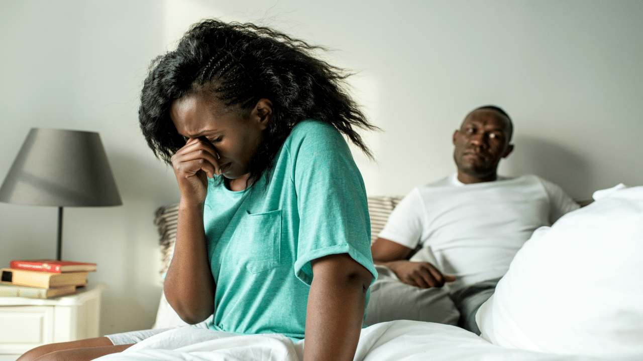 A couple looking upset in the bedroom
