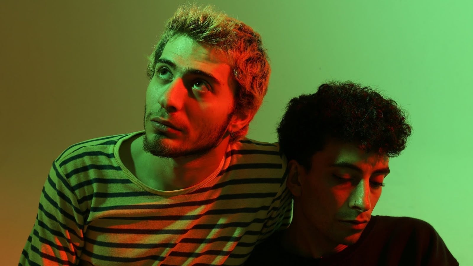 Two men and there is a red and green light