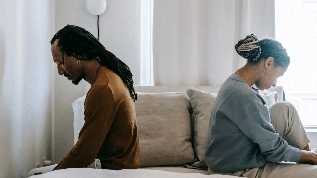 A couple looking upset in the bedroom