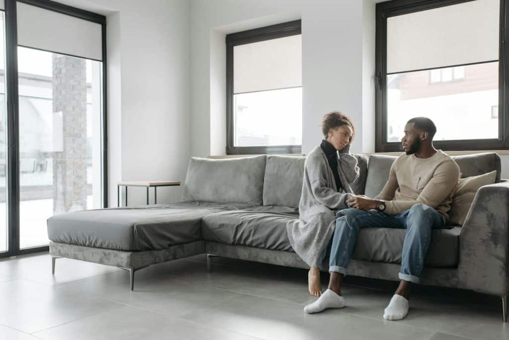 A couple talking on a sofa