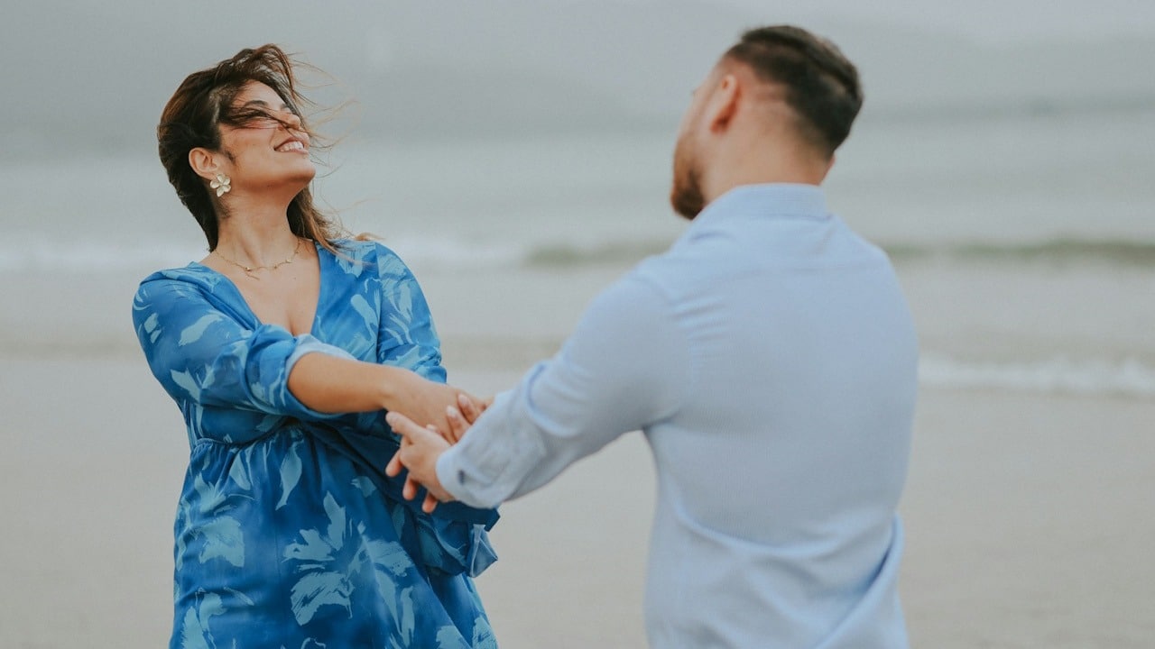A couple enjoying and dancing on the beach.