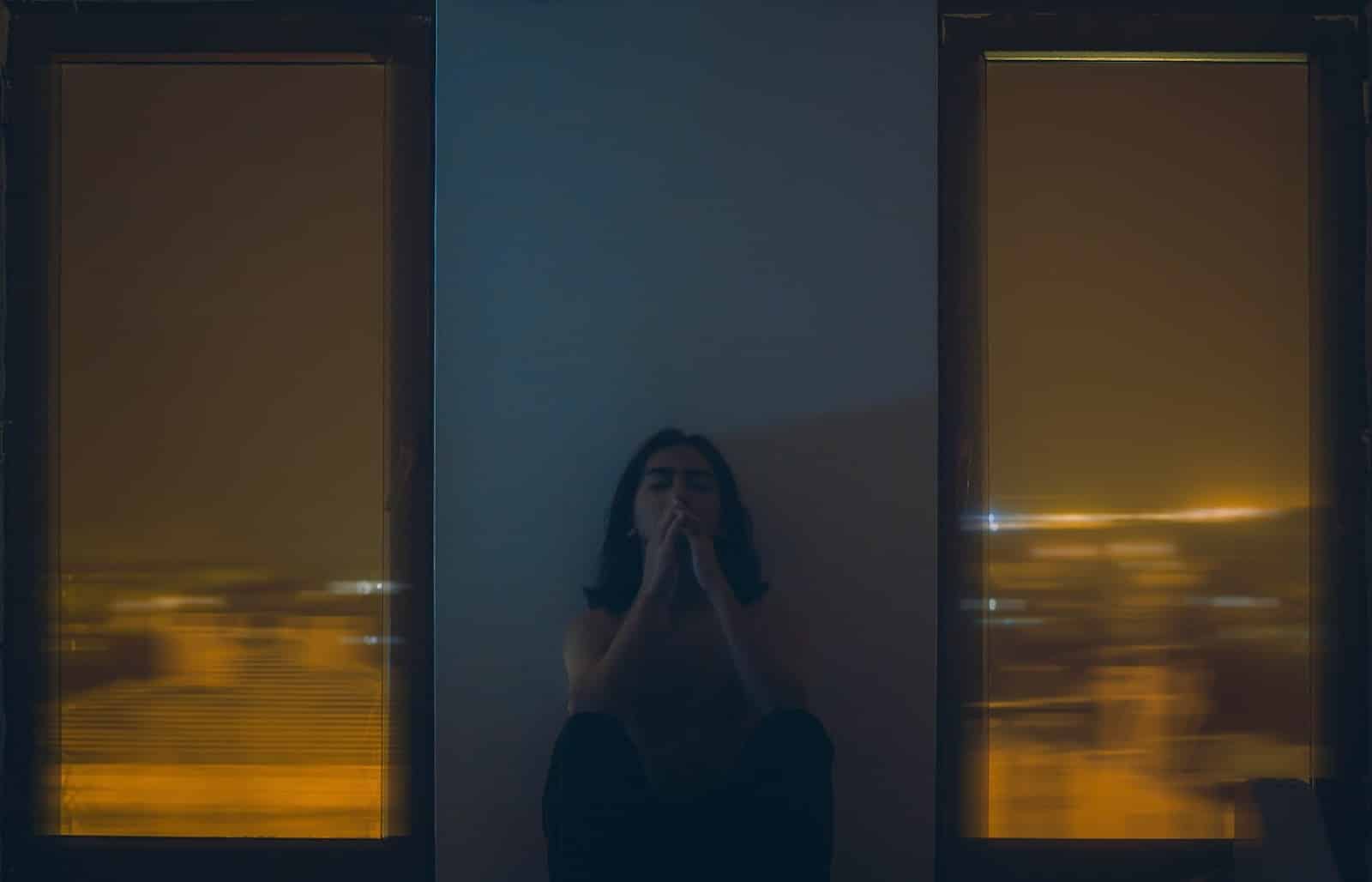 A woman thinking alone at night