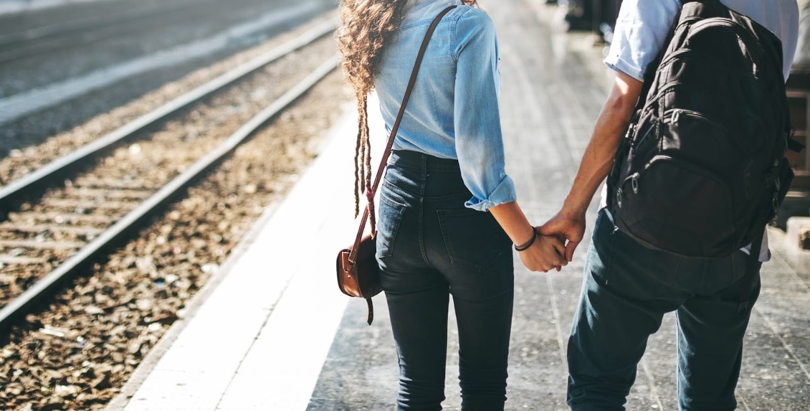 A couple holding hands while walking