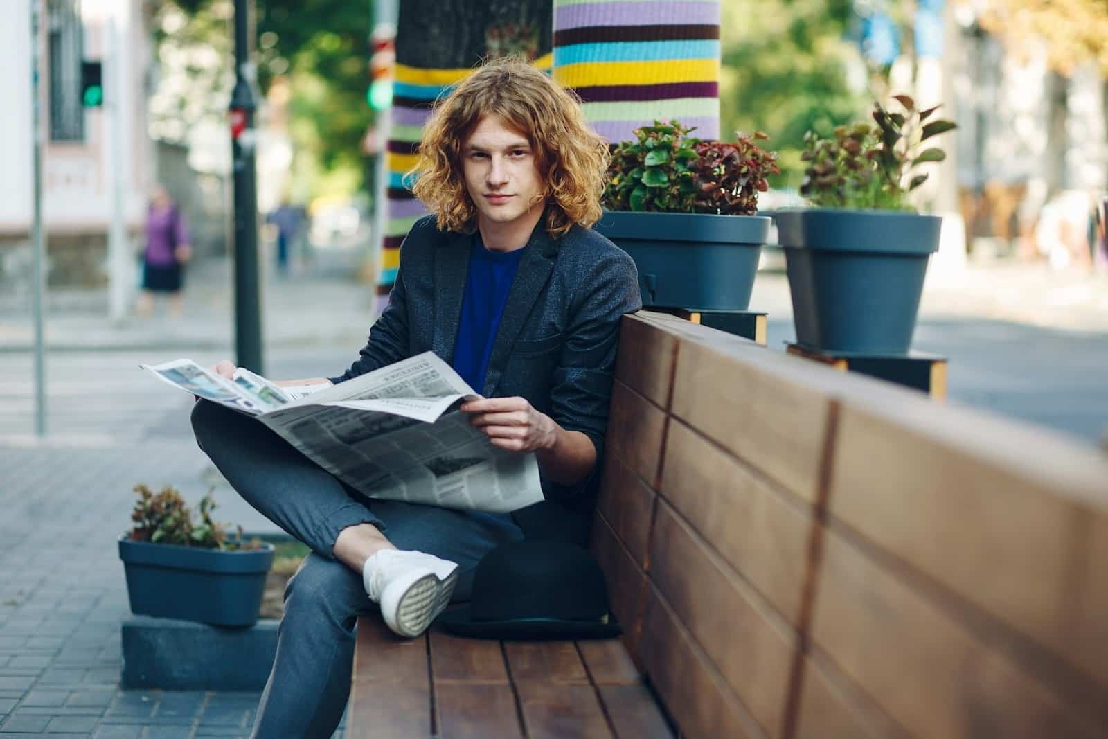 A man sitting confidently in an urban setting