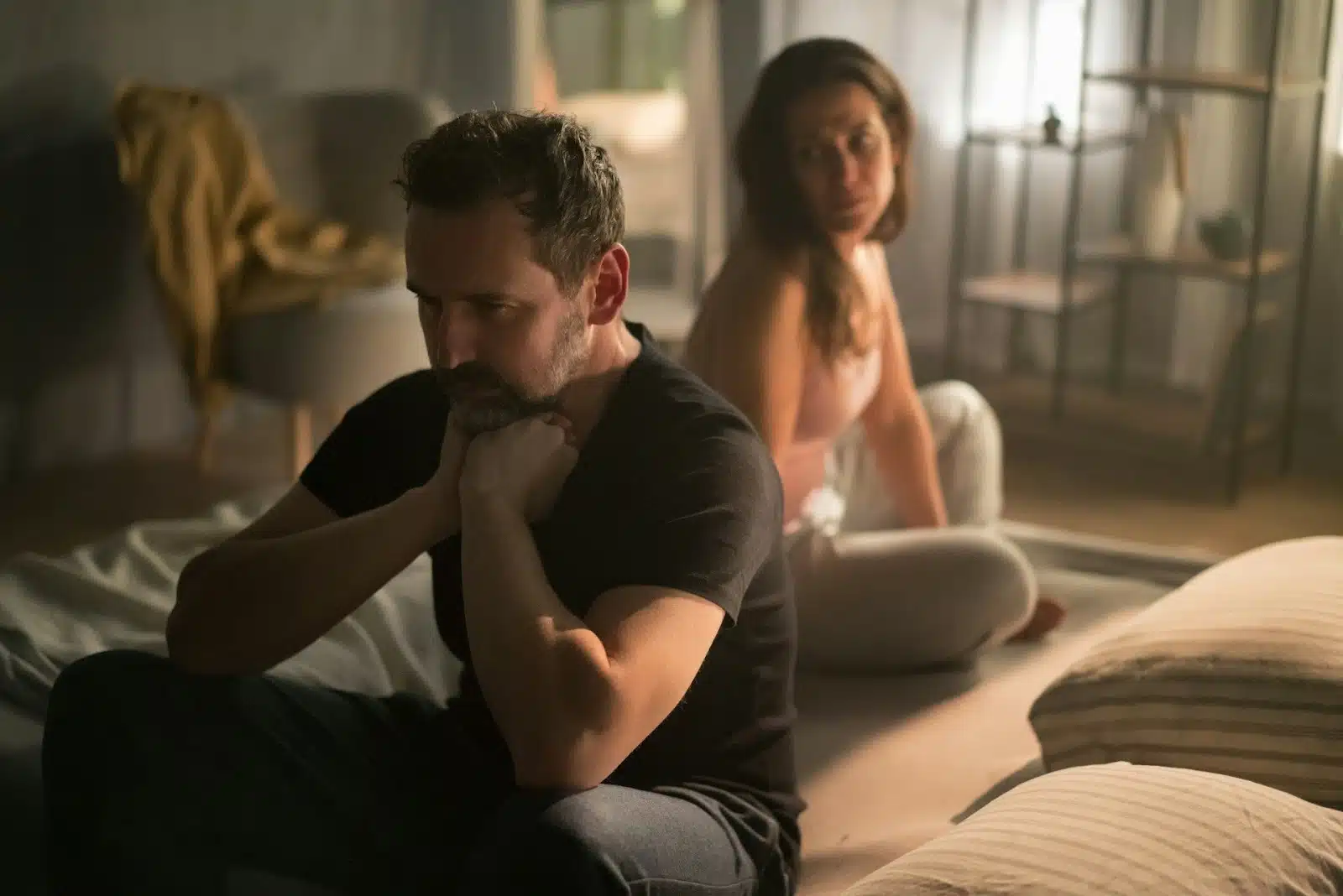 A silent tension indoors between a couple