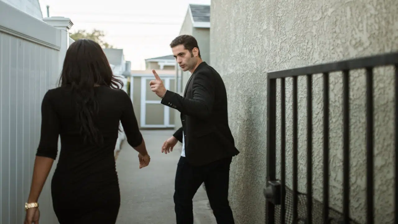 A couple arguing outside their home