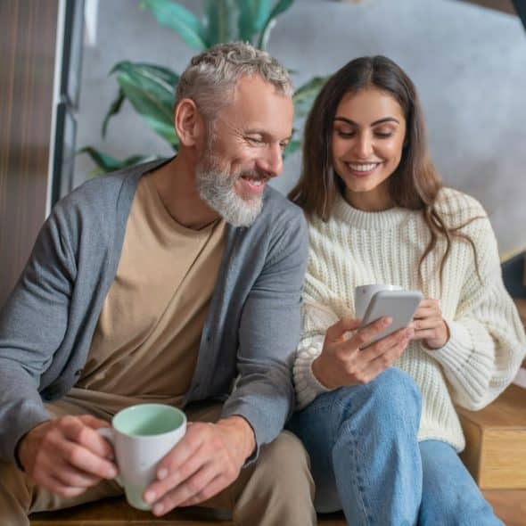 A couple smiling at phone