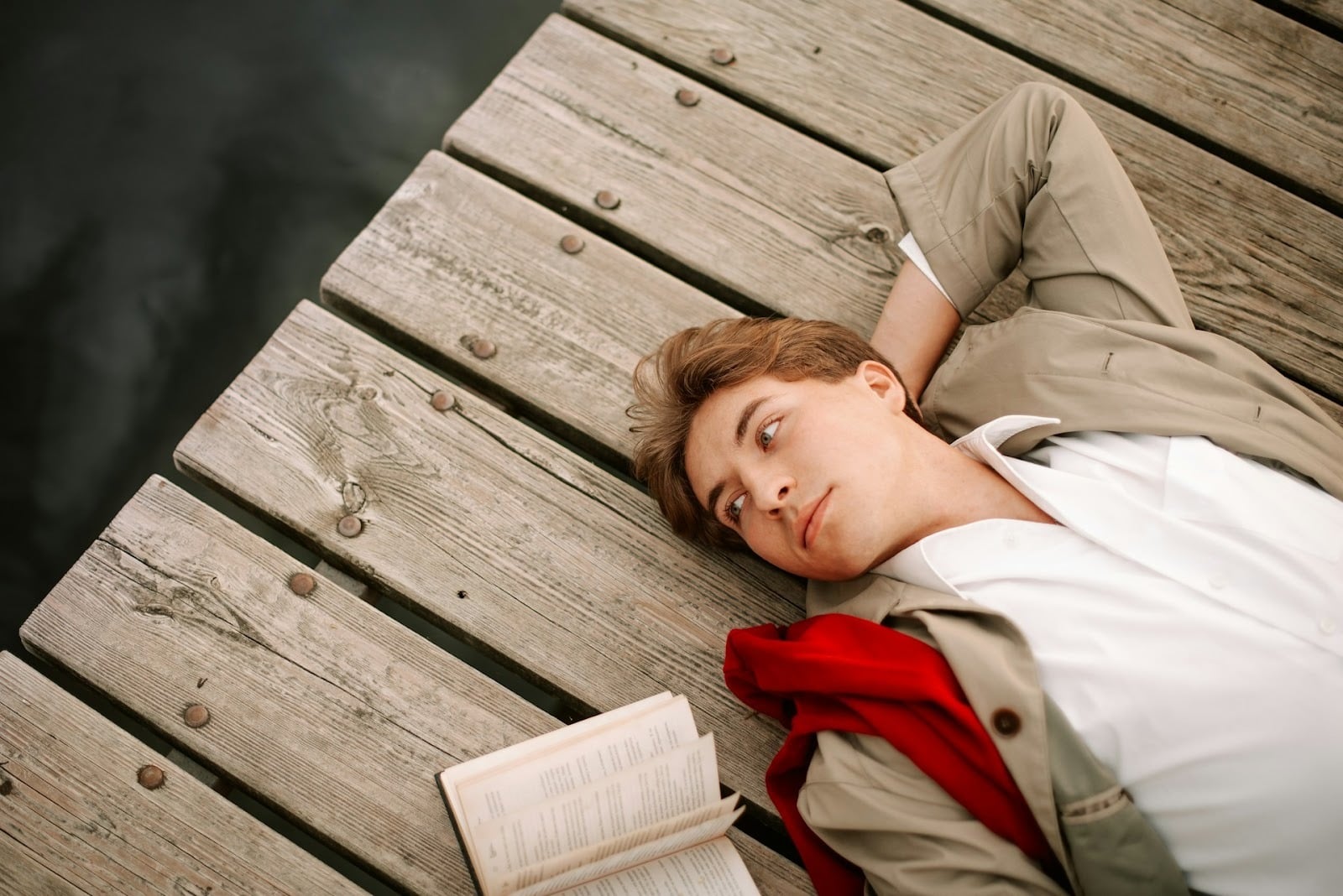 A man lying in the floor with a book
