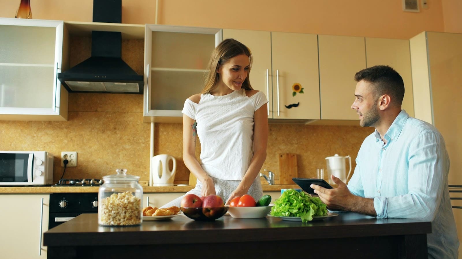 A couple in a kitchen preparing a meal
