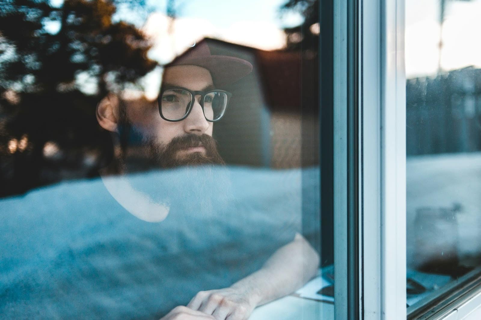 A man thinking by the window