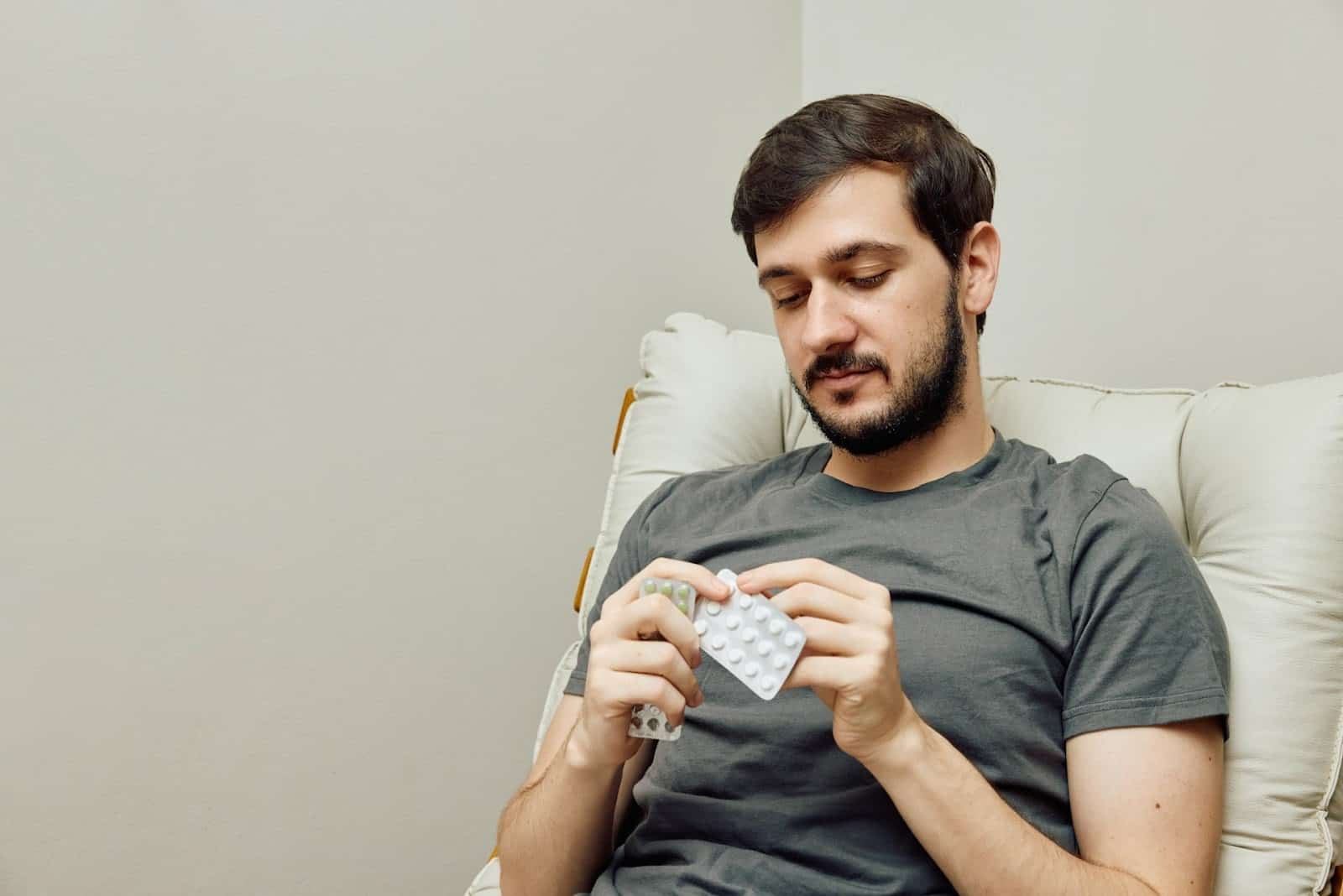 A man opening a pack of medicine