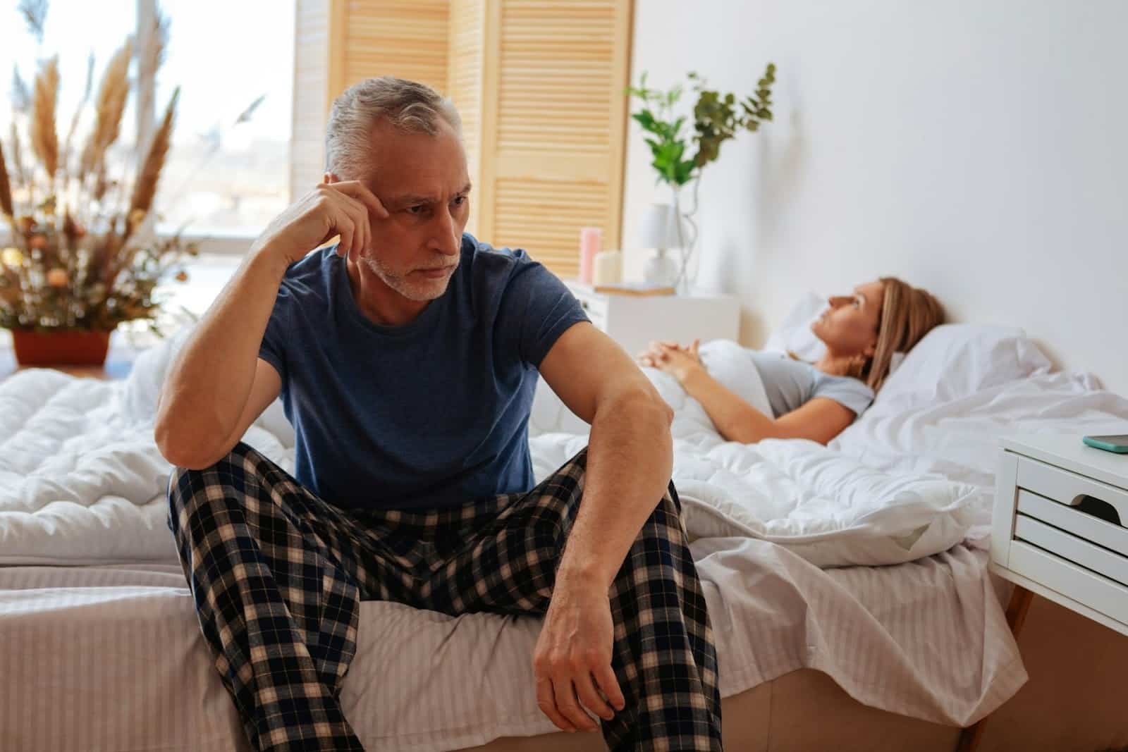 A stressed couple in their bedroom