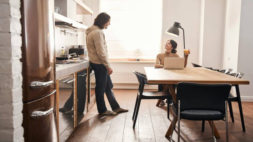 A couple talking in the kitchen