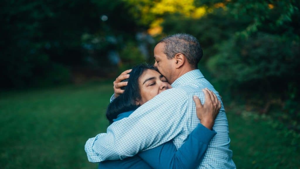 A woman comforting her husband