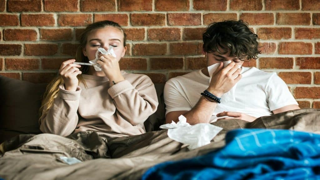 A couple sick in bed 