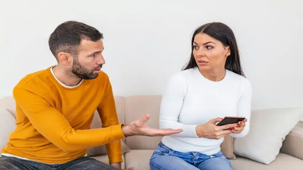 A man confronting his wife about who she’s texting