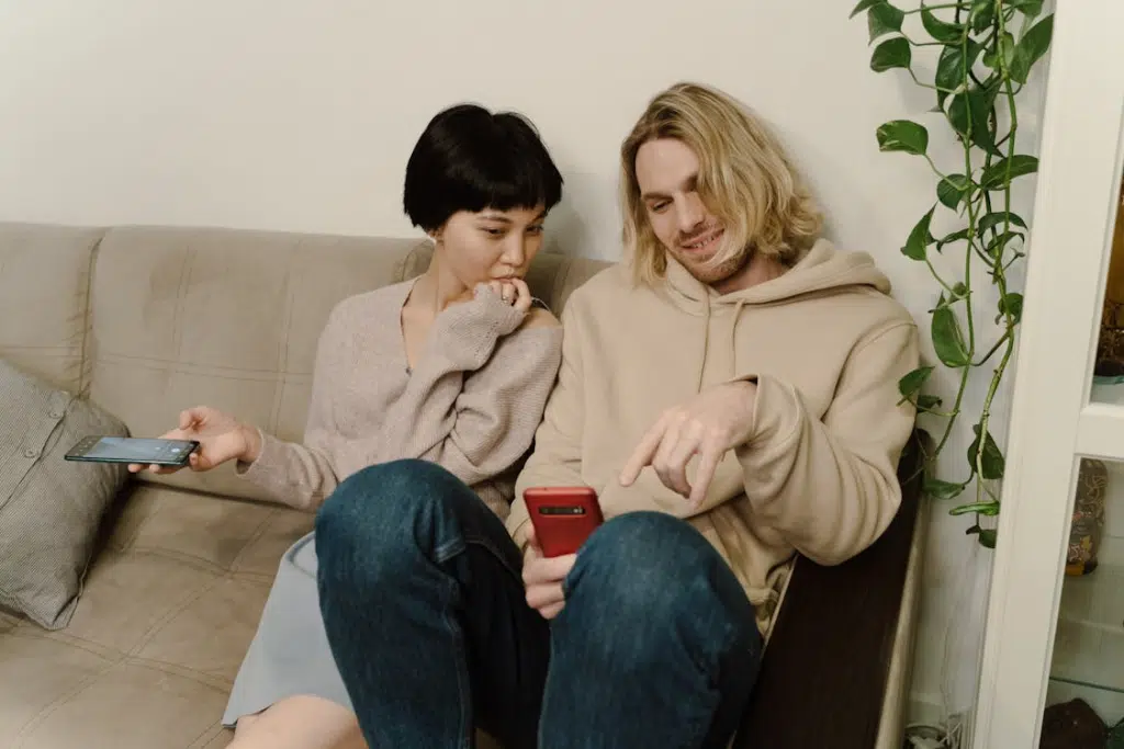 Close-Up Shot of a Man and Woman Looking at the Cellphone