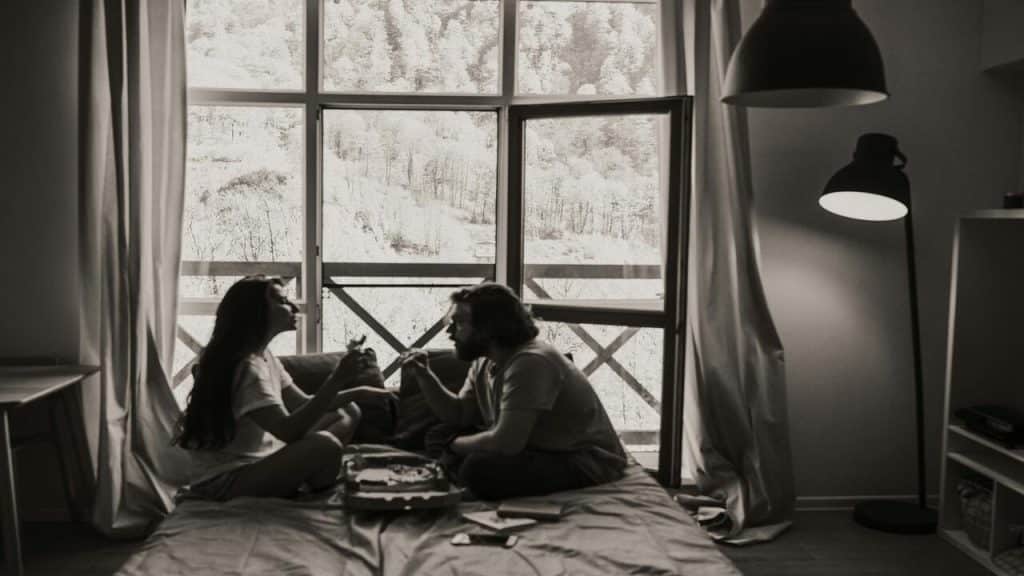 A couple eating in bed