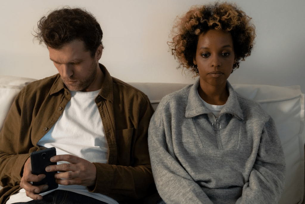 Couple sitting together unhappily