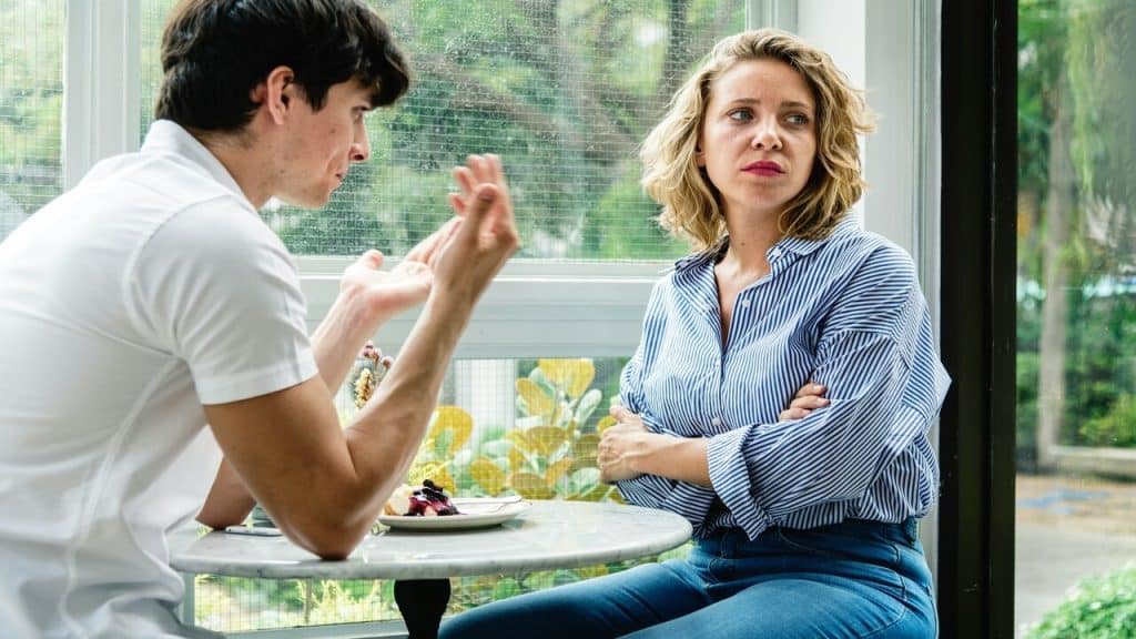 A couple looking sad at a cafe