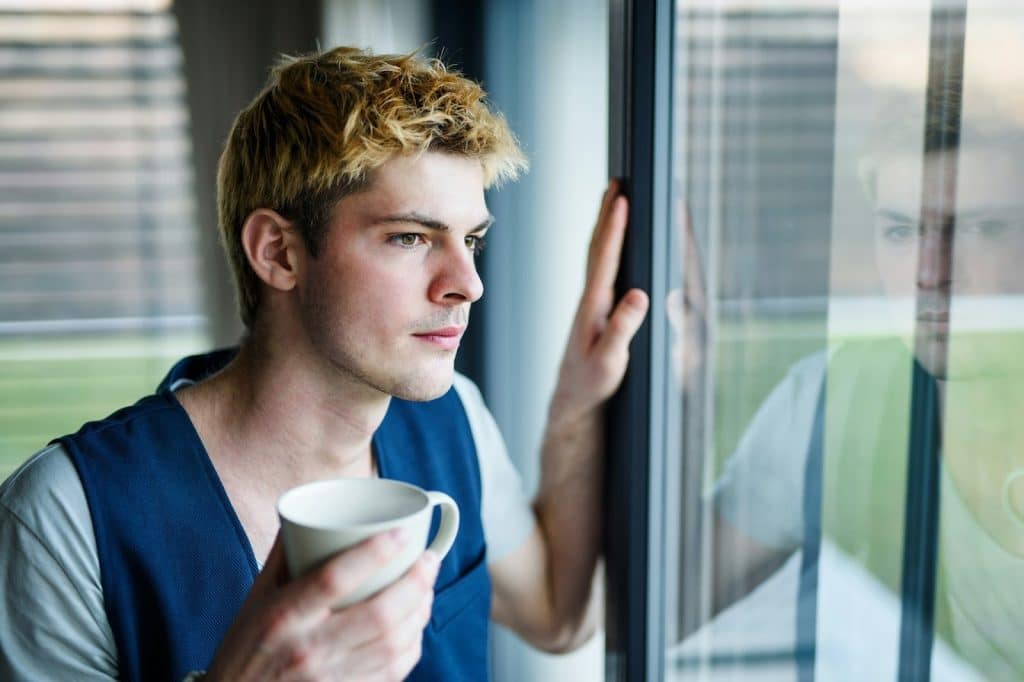 man looking away window light