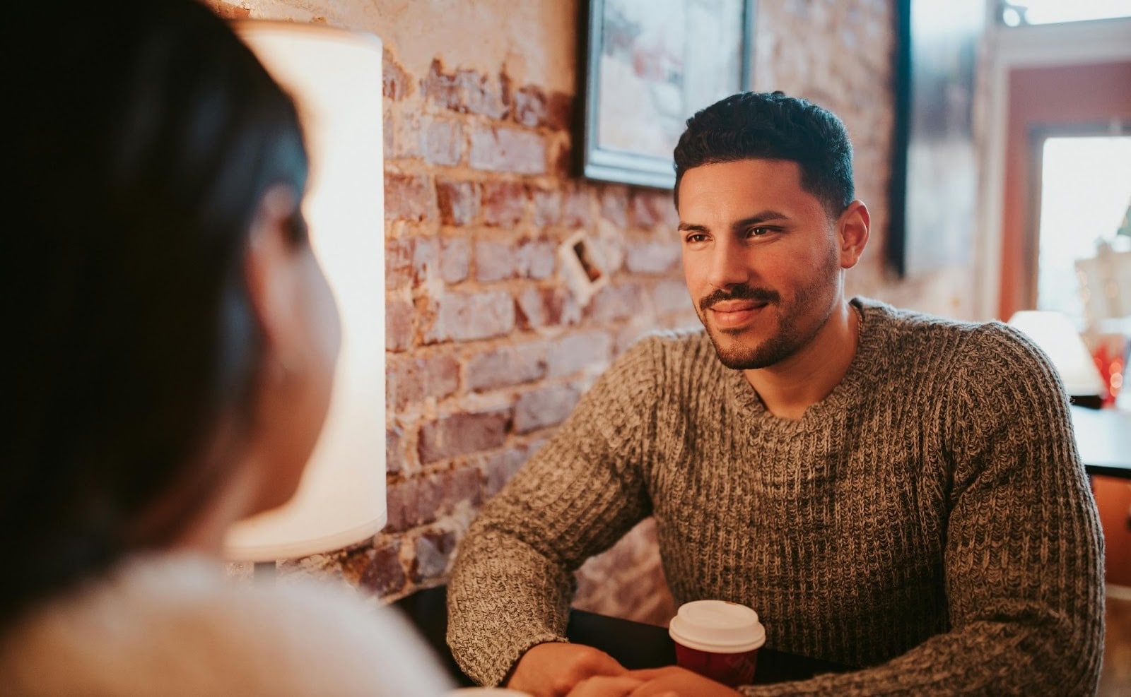 A man smiling to woman