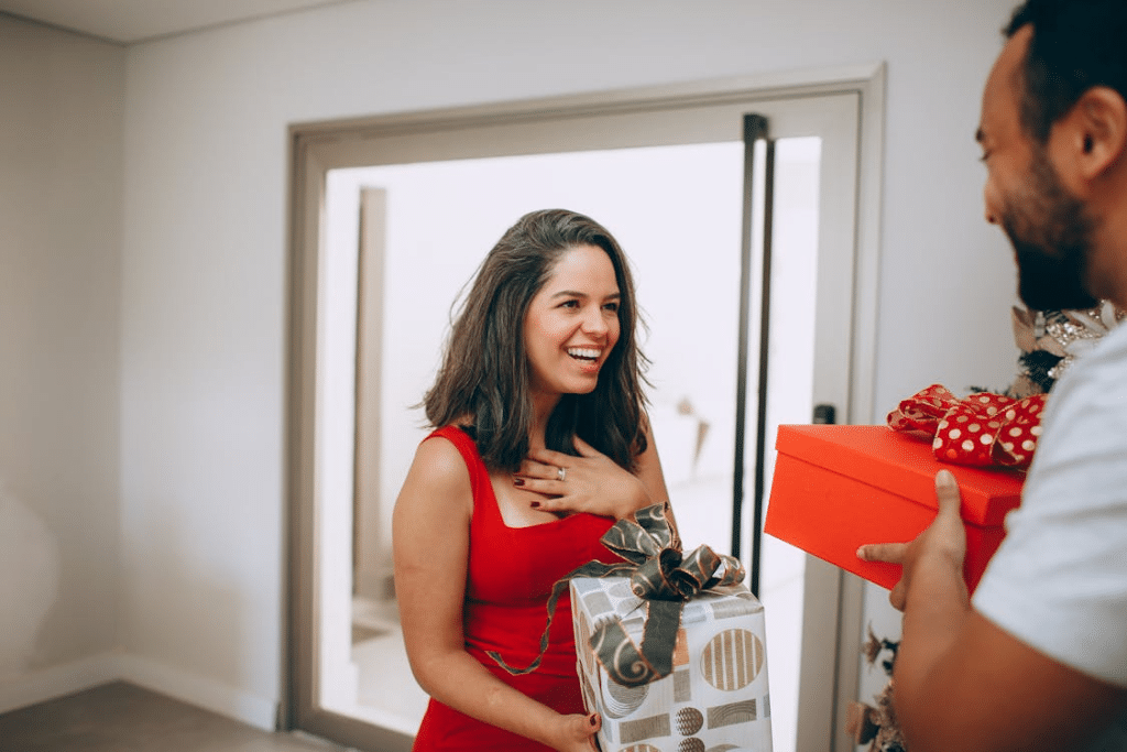 A man and a woman holding presents