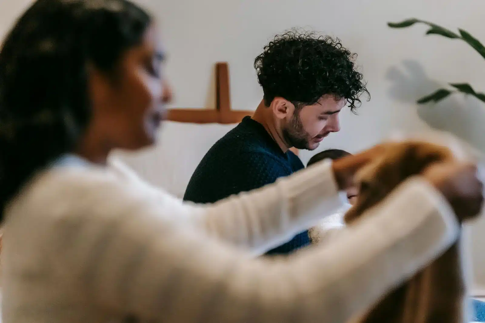 A man and woman being silent while doing house chores