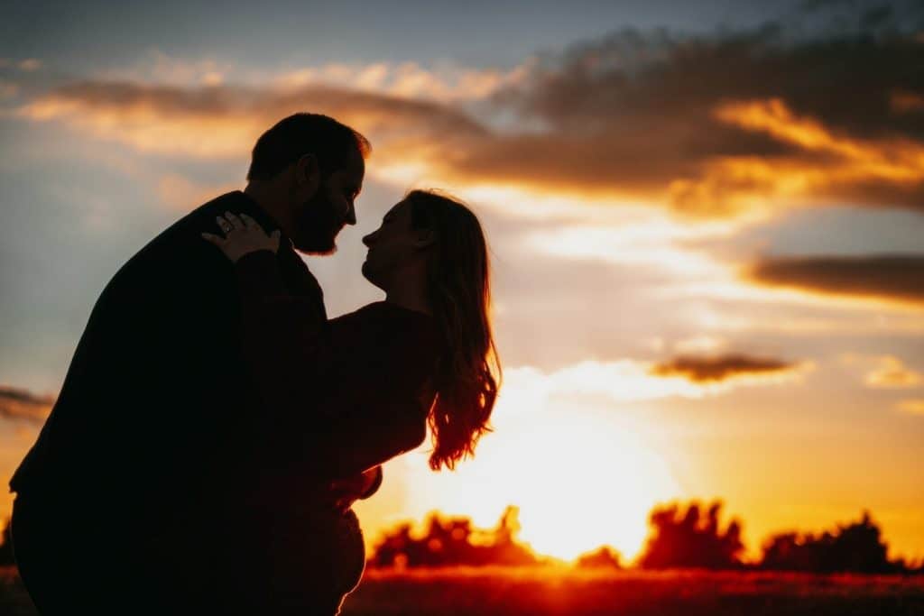 couple hugging sunset