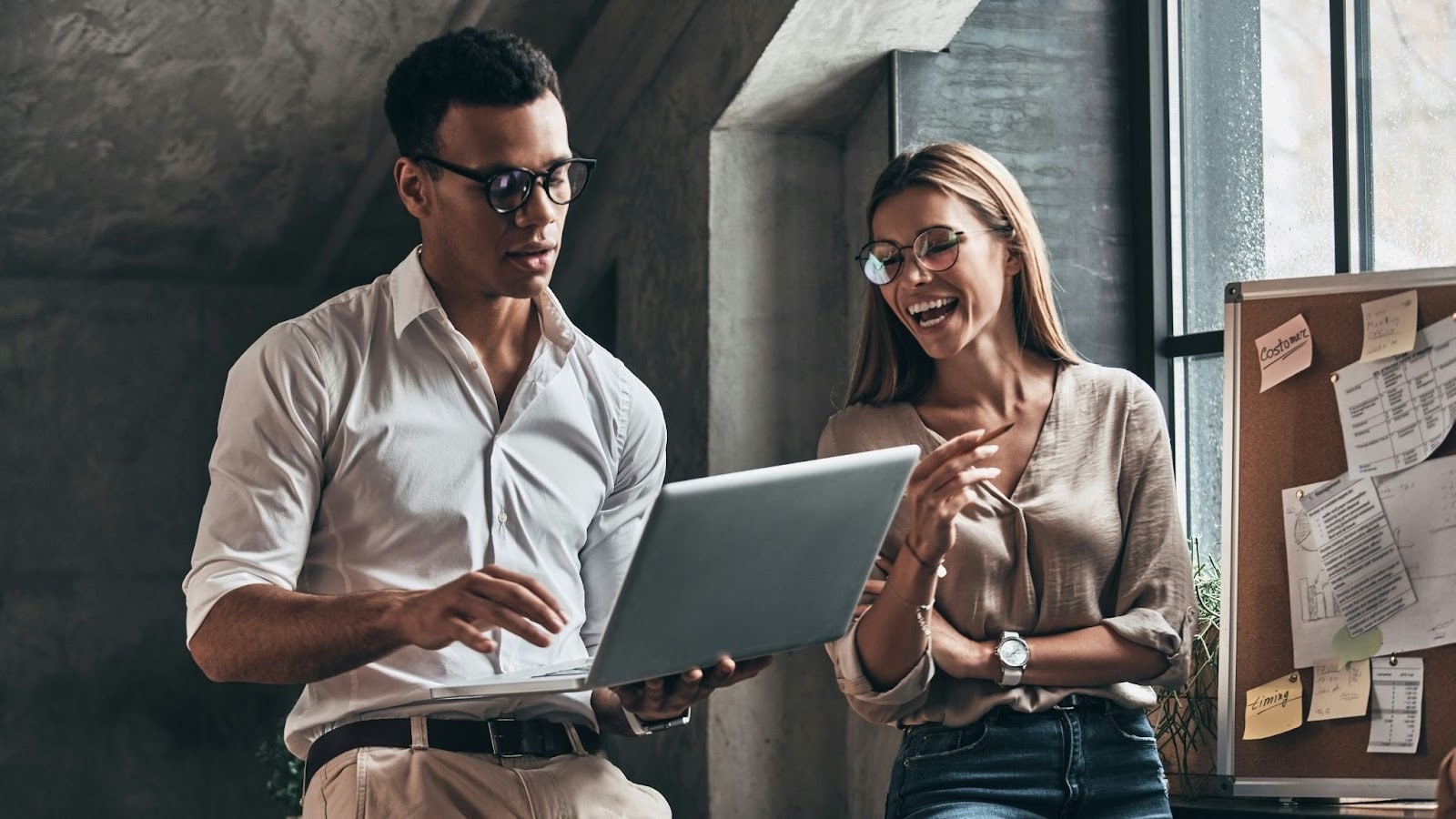 A man busy working and a woman trying to speak with him