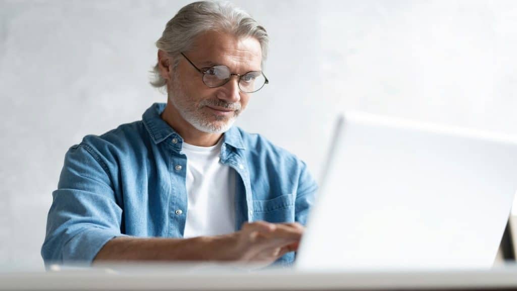 A handsome mature man using his laptop