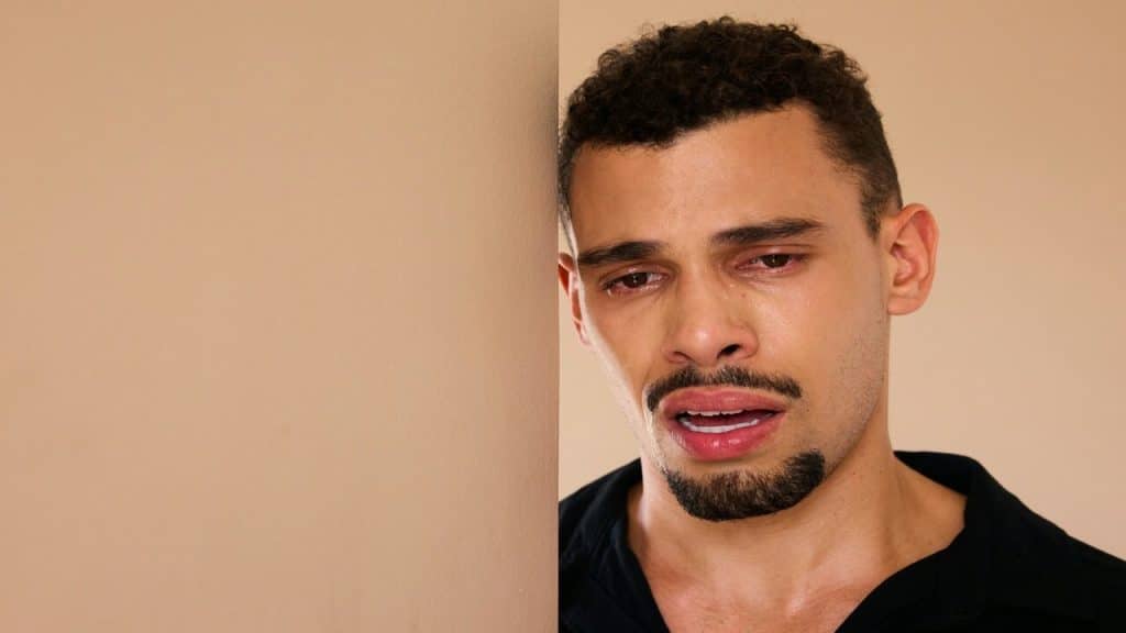 A man crying by himself