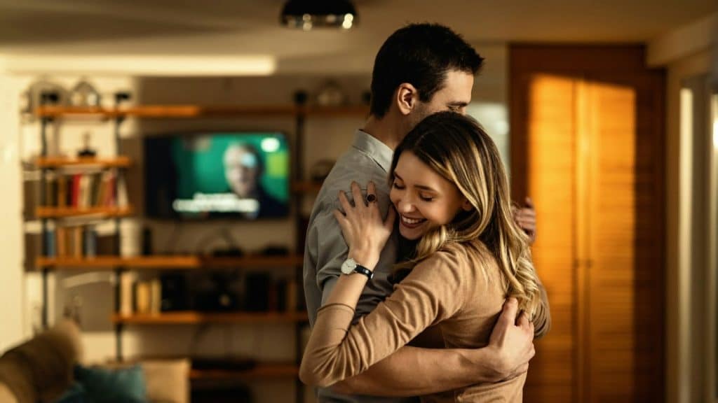 A man hugging a woman 