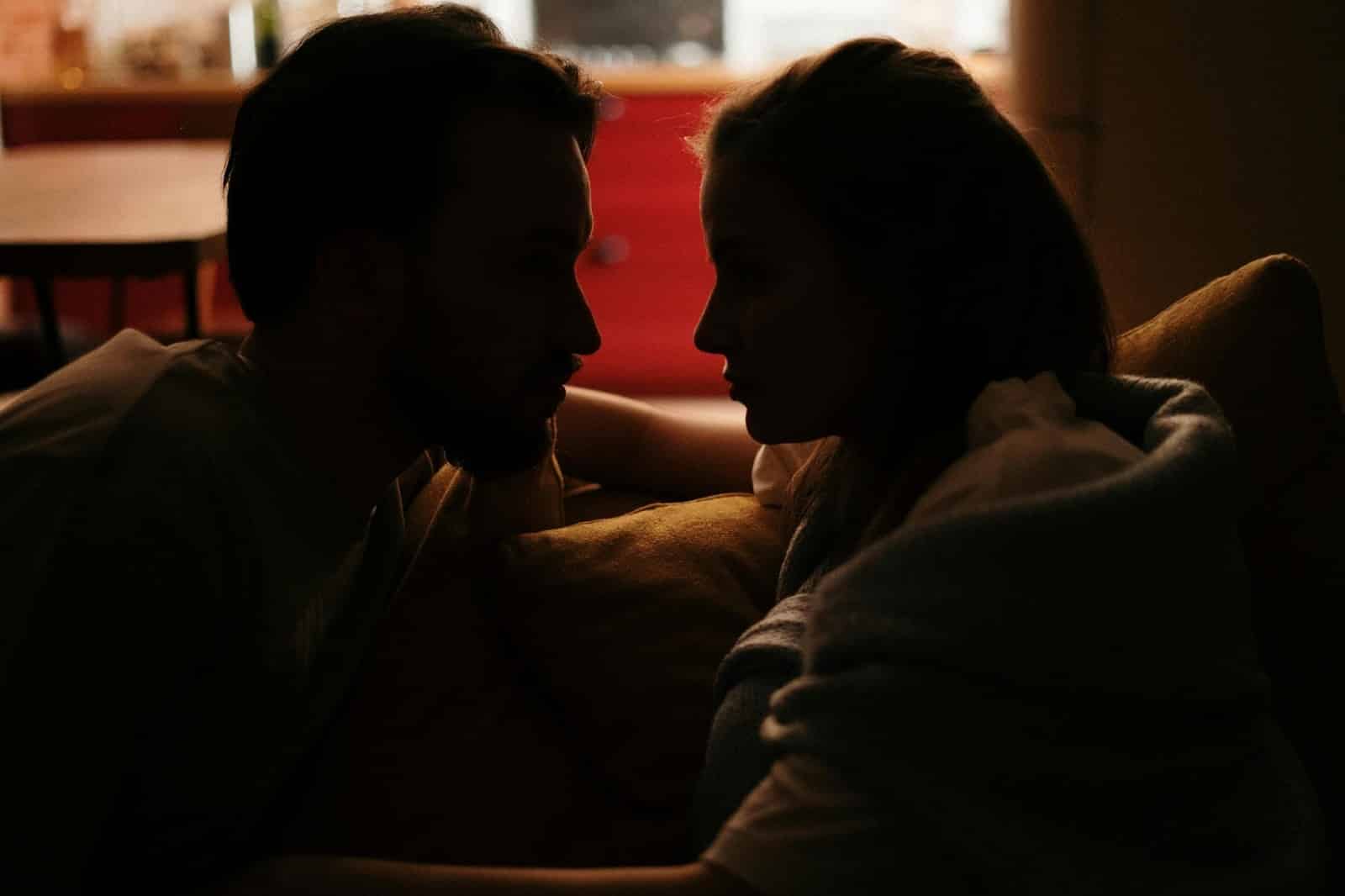 A silhouette of a couple looking at each other