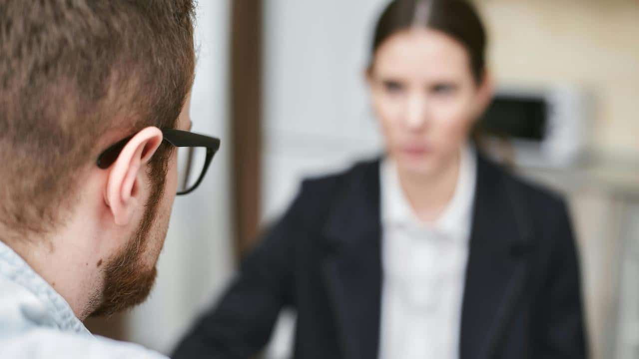 A man facing a woman