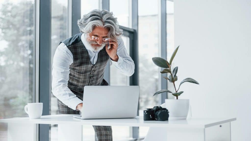 A handsome older man working in an office