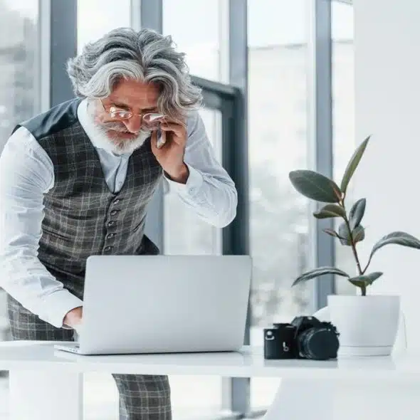 A handsome older man working in an office