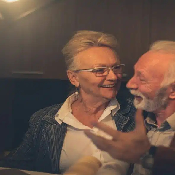 An older couple arguing but still smiling