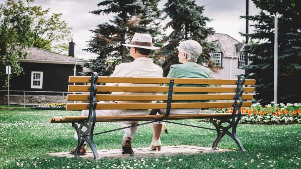 An older couple sitting on a bench