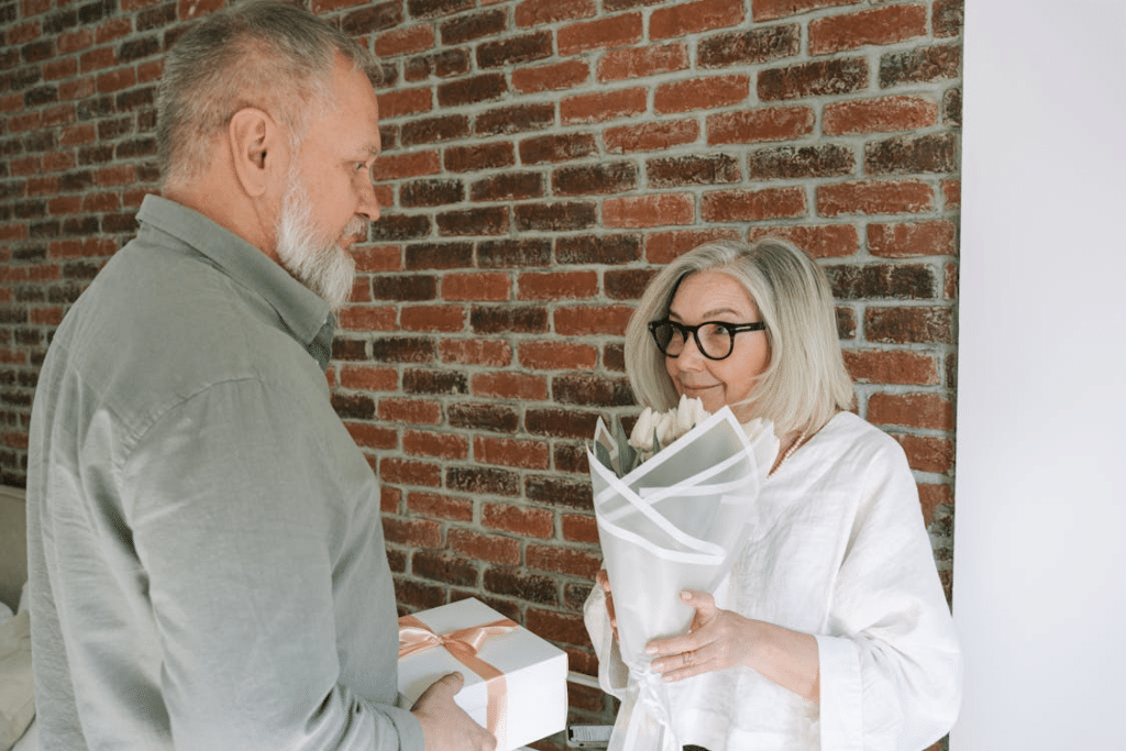 A man giving flowers and a present to a woman