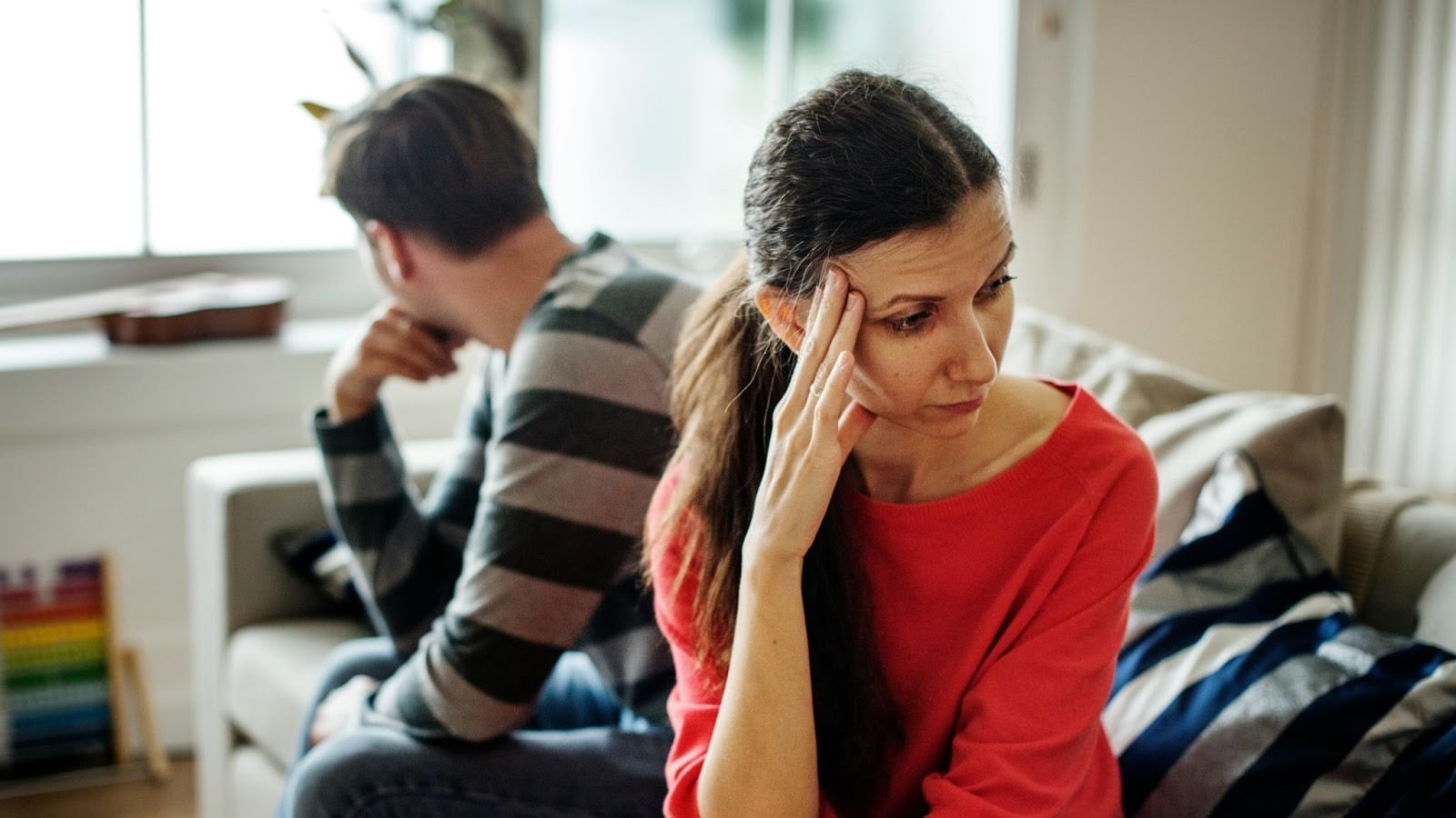 Woman thinking and a man behind her