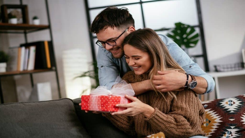 A man giving his wife a gift